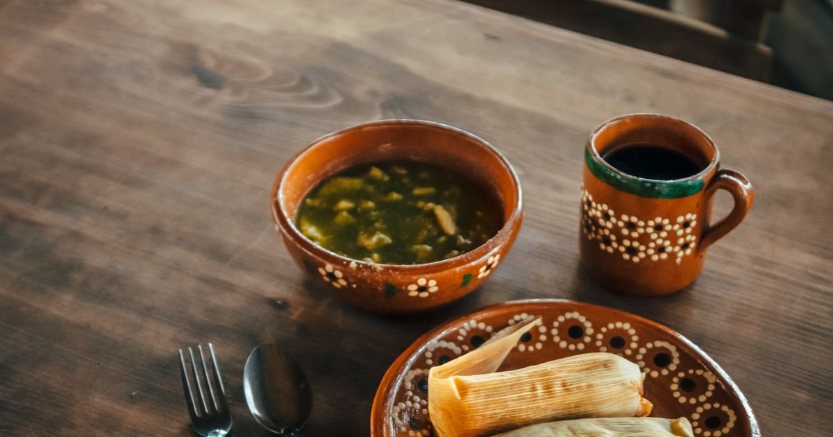 Tamales y sopa servidos en vajilla de barro